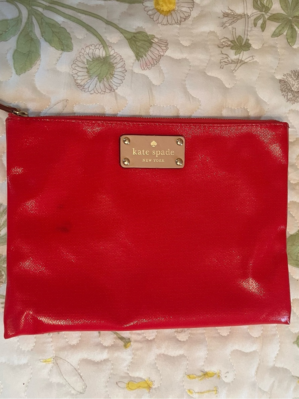 kate spade red travel pouch with gold logo plate